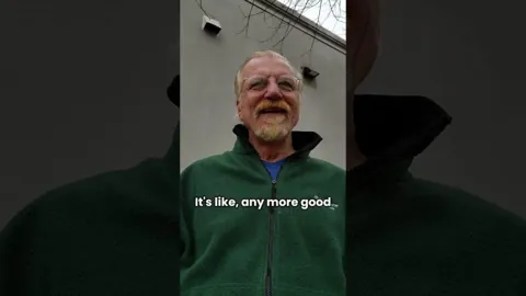 Andrew Anderson recording a video outdoors in a green fleece