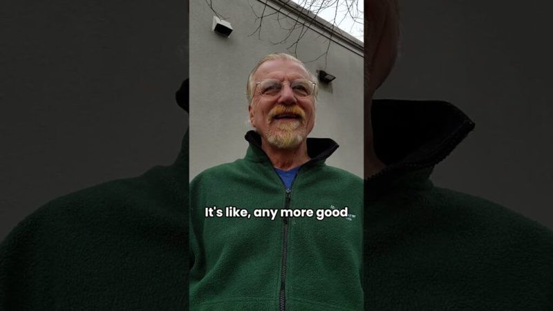 Andrew Anderson recording a video outdoors in a green fleece